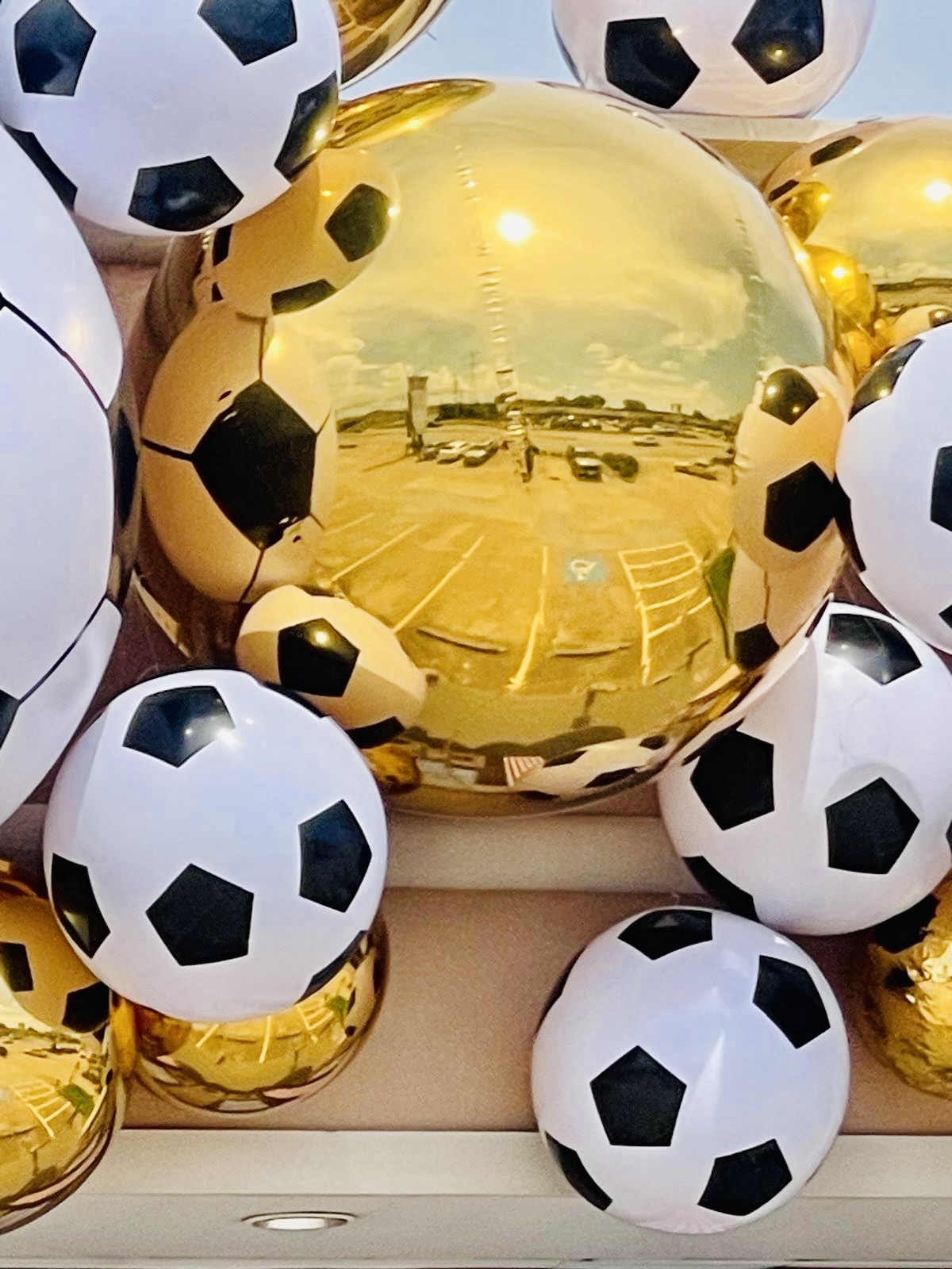 Gold mirror sphere and soccer ball decorations at Karat 22 Jewelers
